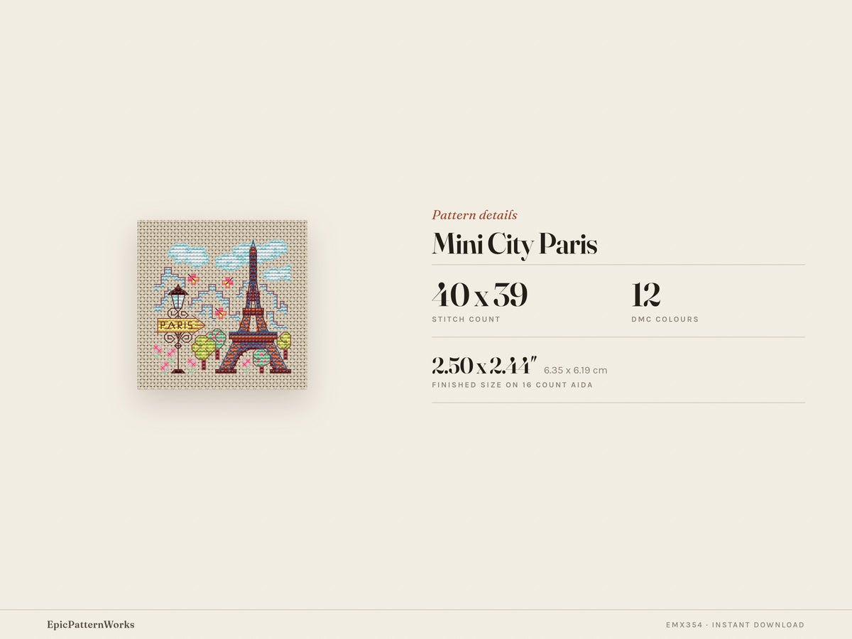 Cross stitch design of a small Paris cityscape showing a colorful Eiffel Tower, streetlamp with Paris sign, trees, clouds, and flowers on beige fabric.
