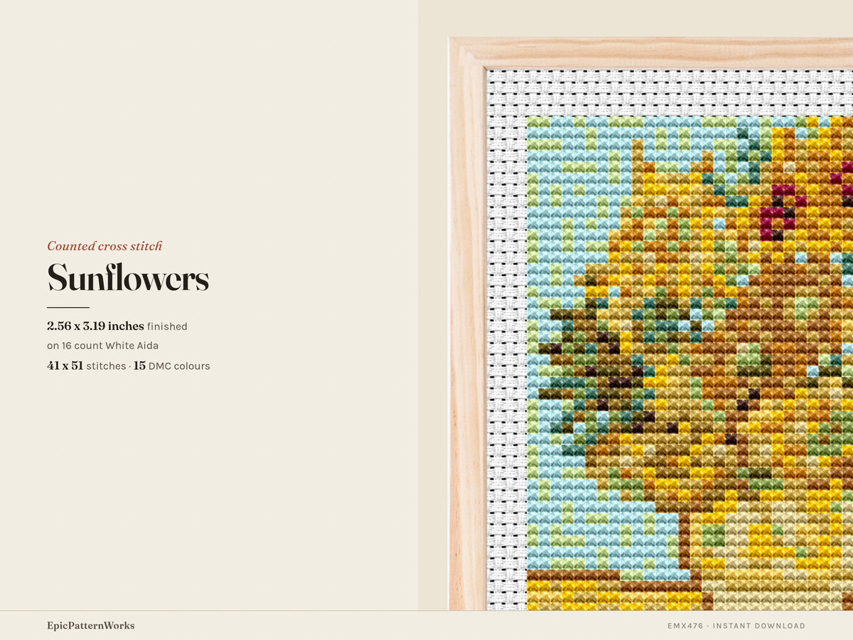 Cross stitch pattern of a vase filled with golden sunflowers on a yellow tabletop against a light blue background, stitched on white aida fabric.