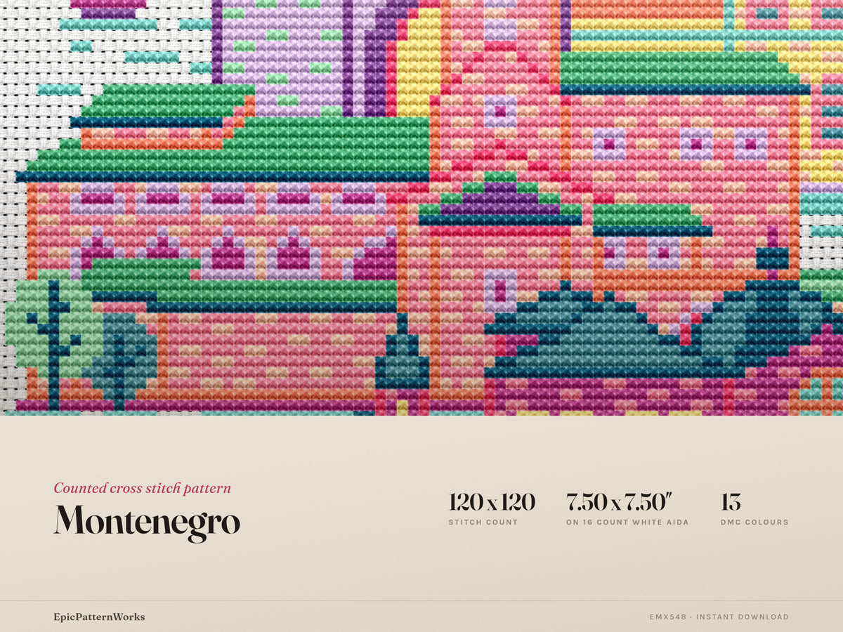Colorful Montenegro-inspired cross stitch pattern showing a coastal cityscape with tall towers, domed buildings, sailboats on the water and dark mountains in the background on white fabric.